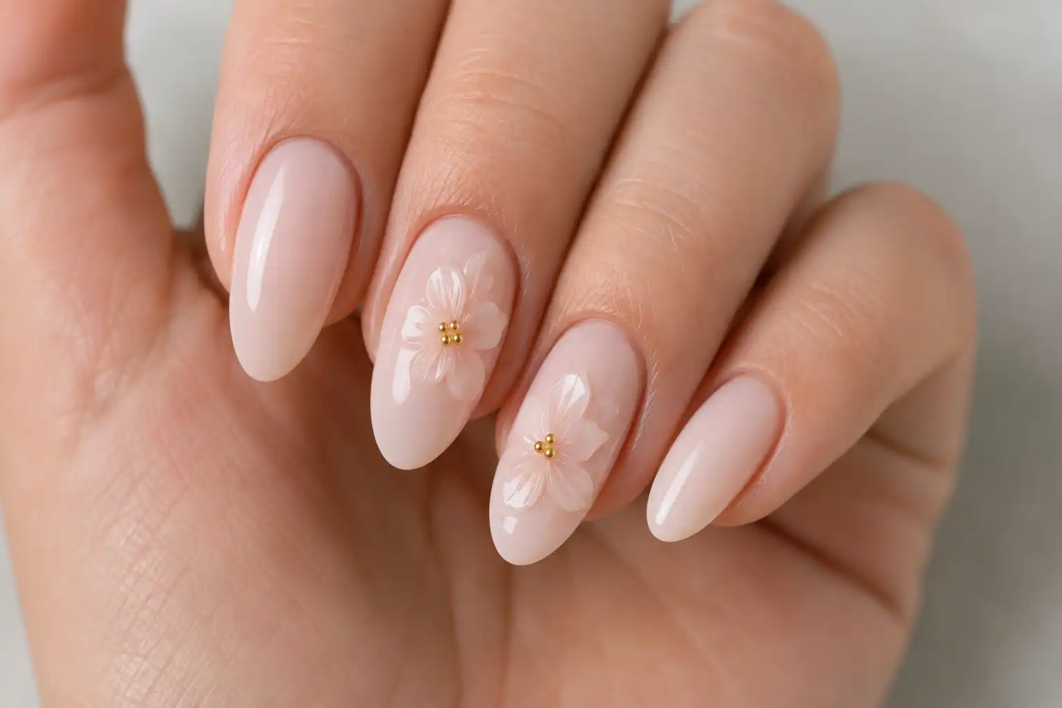 3D sculpted flower nail art with gold accents