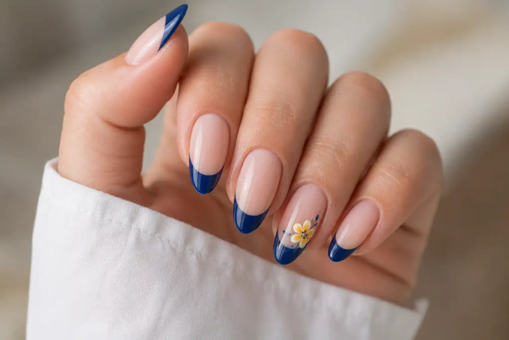 navy french tip nails with yellow floral accent