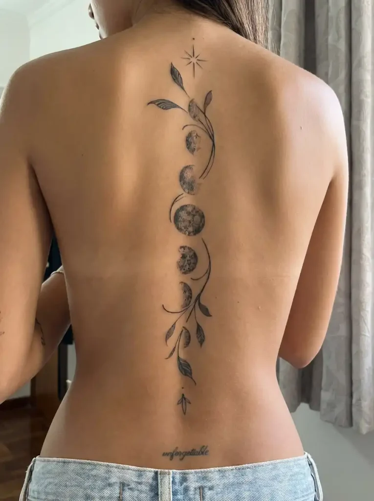 Moon phases woven through a botanical vine spine tattoo
