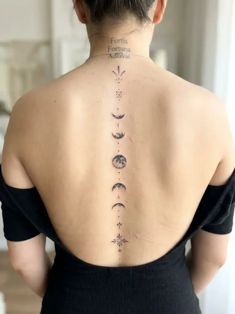 Moon phases vertical linework tattoo along the spine