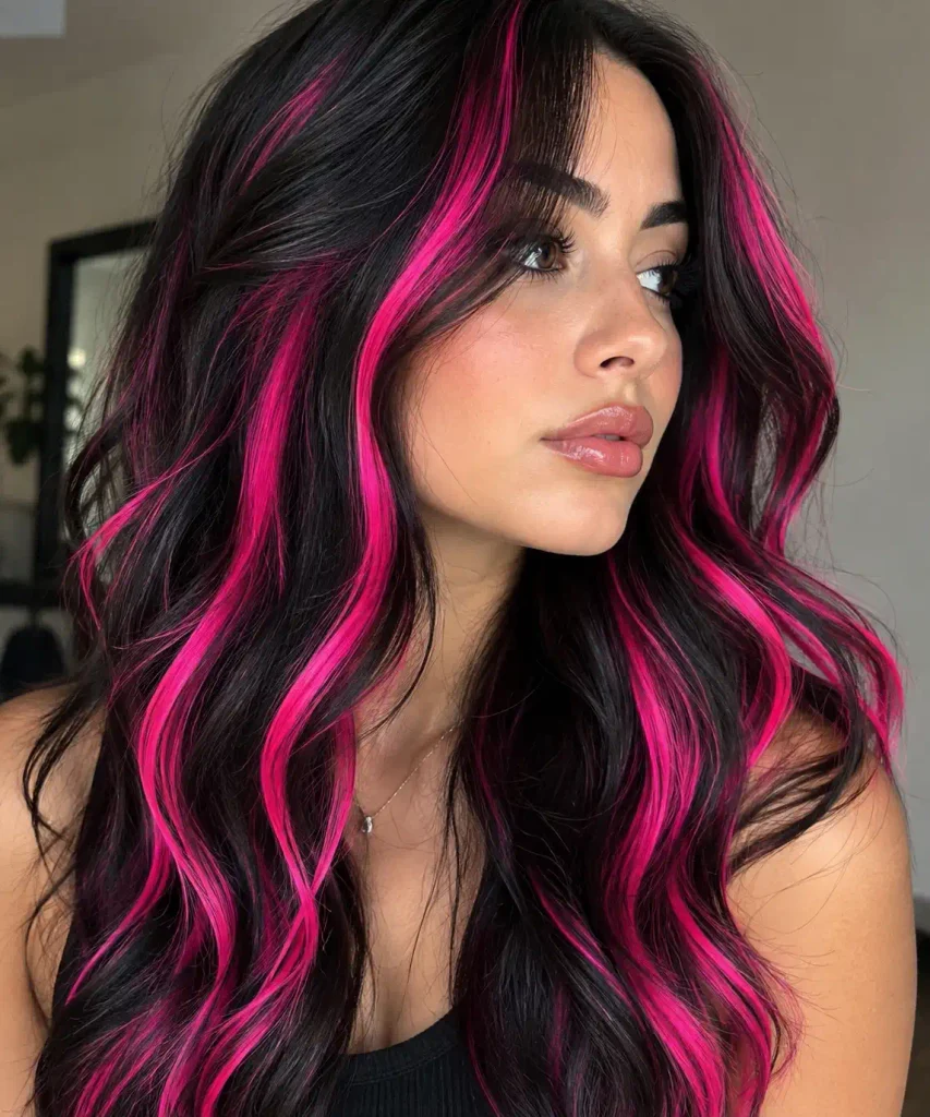Bold neon pink streaks in dark hair